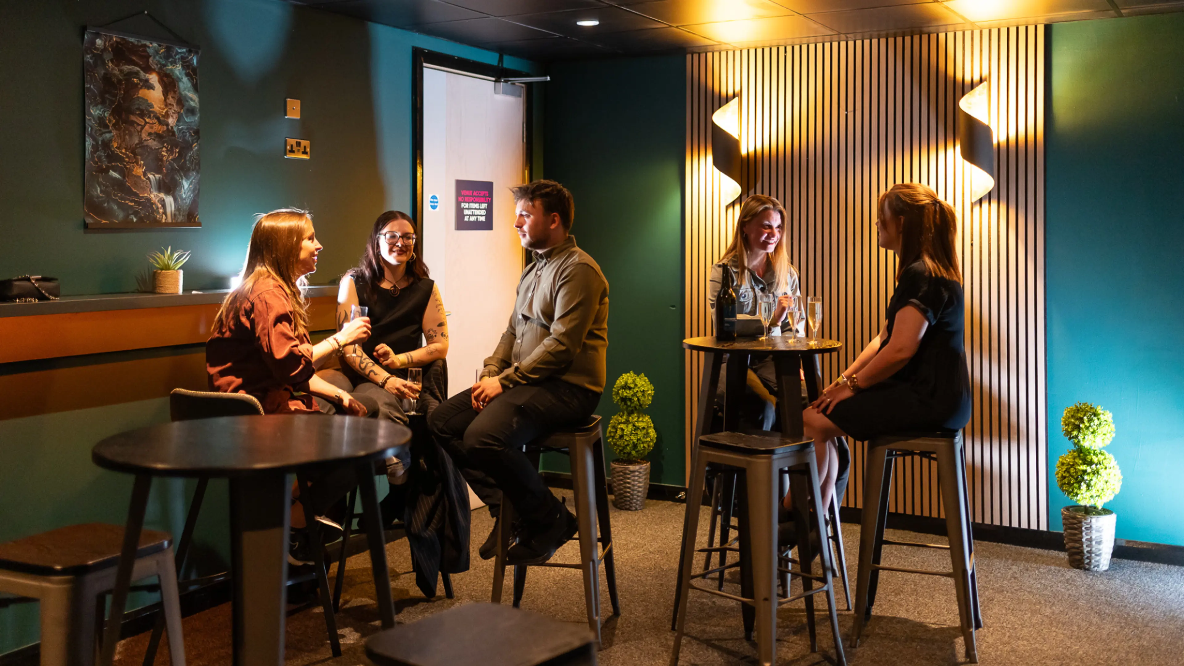 The Suite Experience at Utilita Arena Cardiff, full of people chatting, drinking and having a good time.