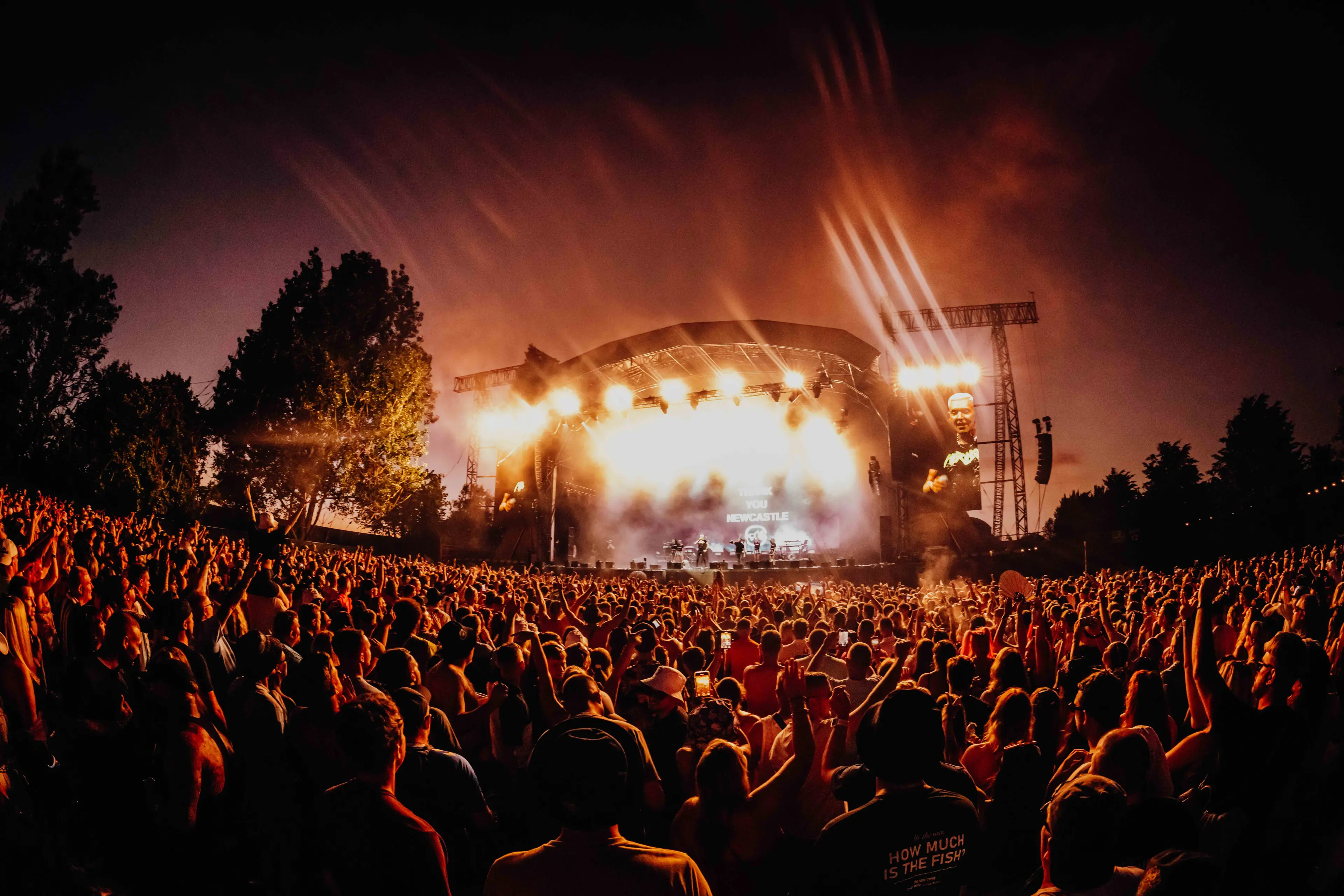 Stage with lights on and large crowd