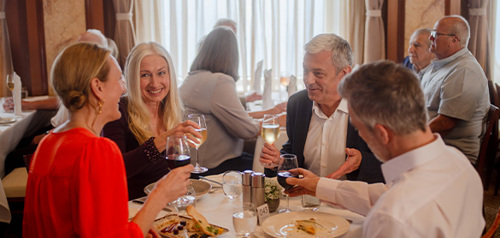 Group of people enjoying a dining experience on the Ambience