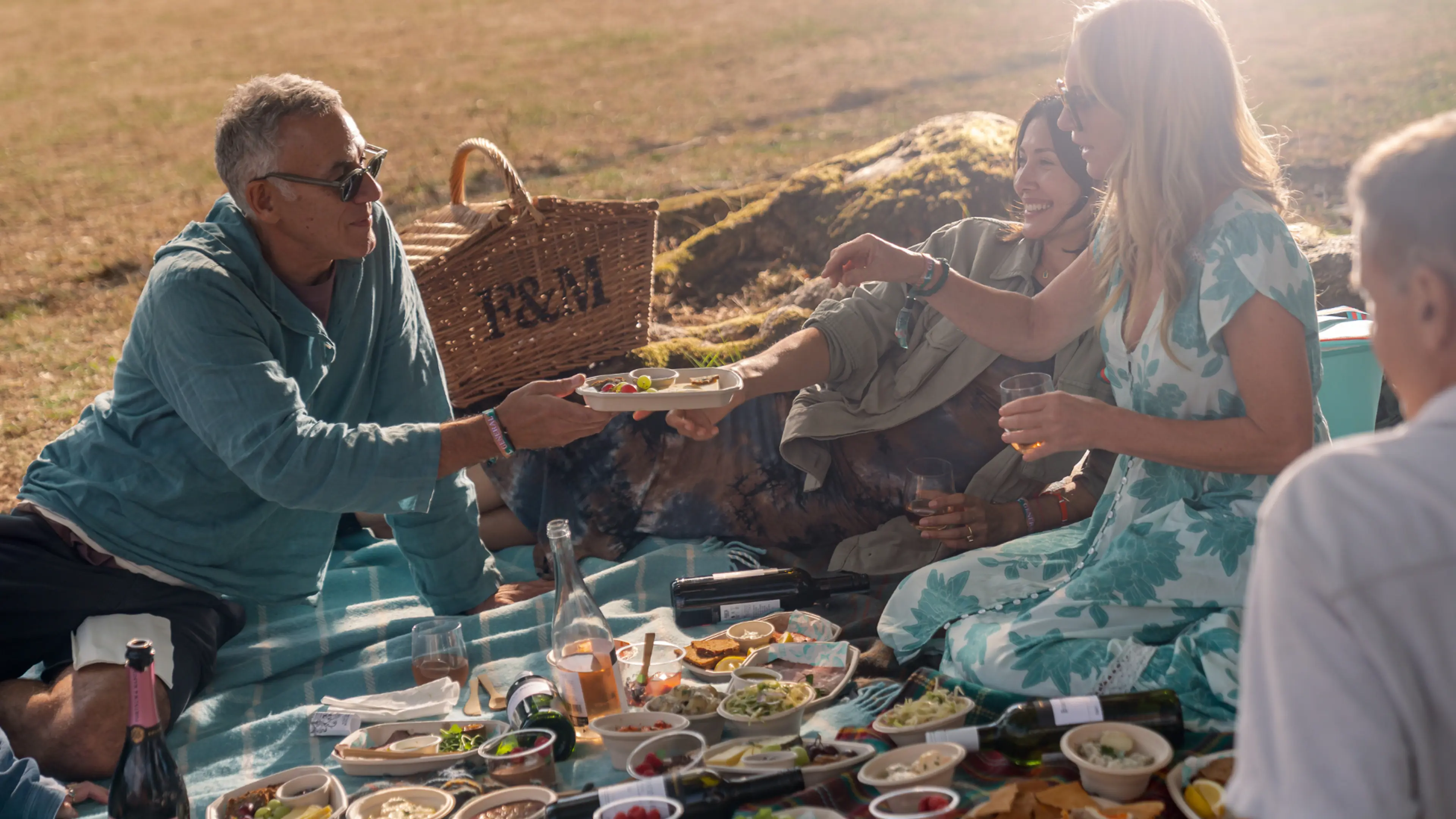 People enjoying the food in the Fortnum & Mason hamper