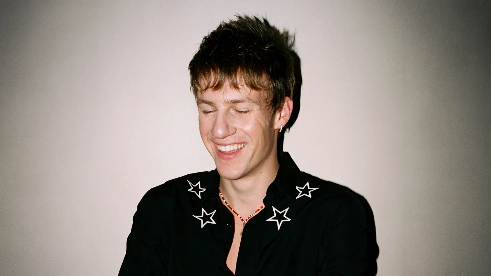 Malcolm Todd in a black shirt with stars in the collar