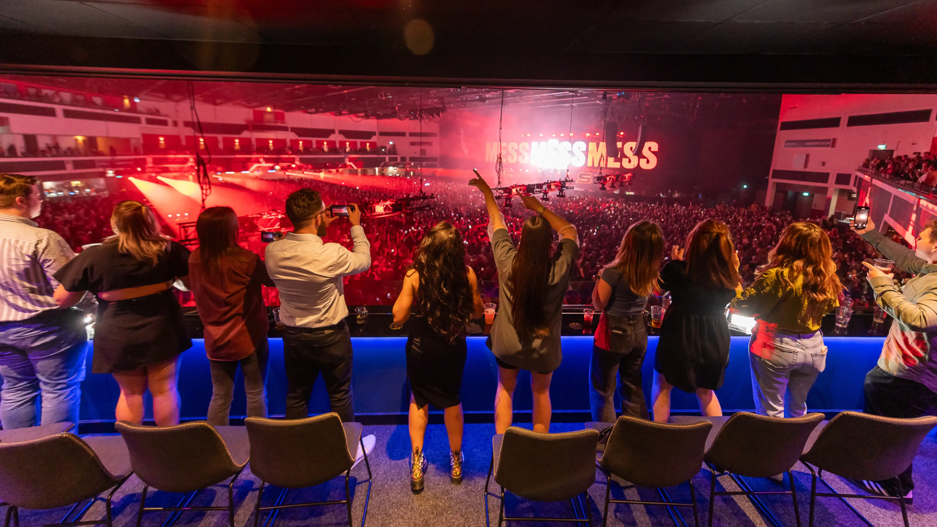 People dancing gainst the balcony at the Energise Club at Utilita Arena Cardiff.