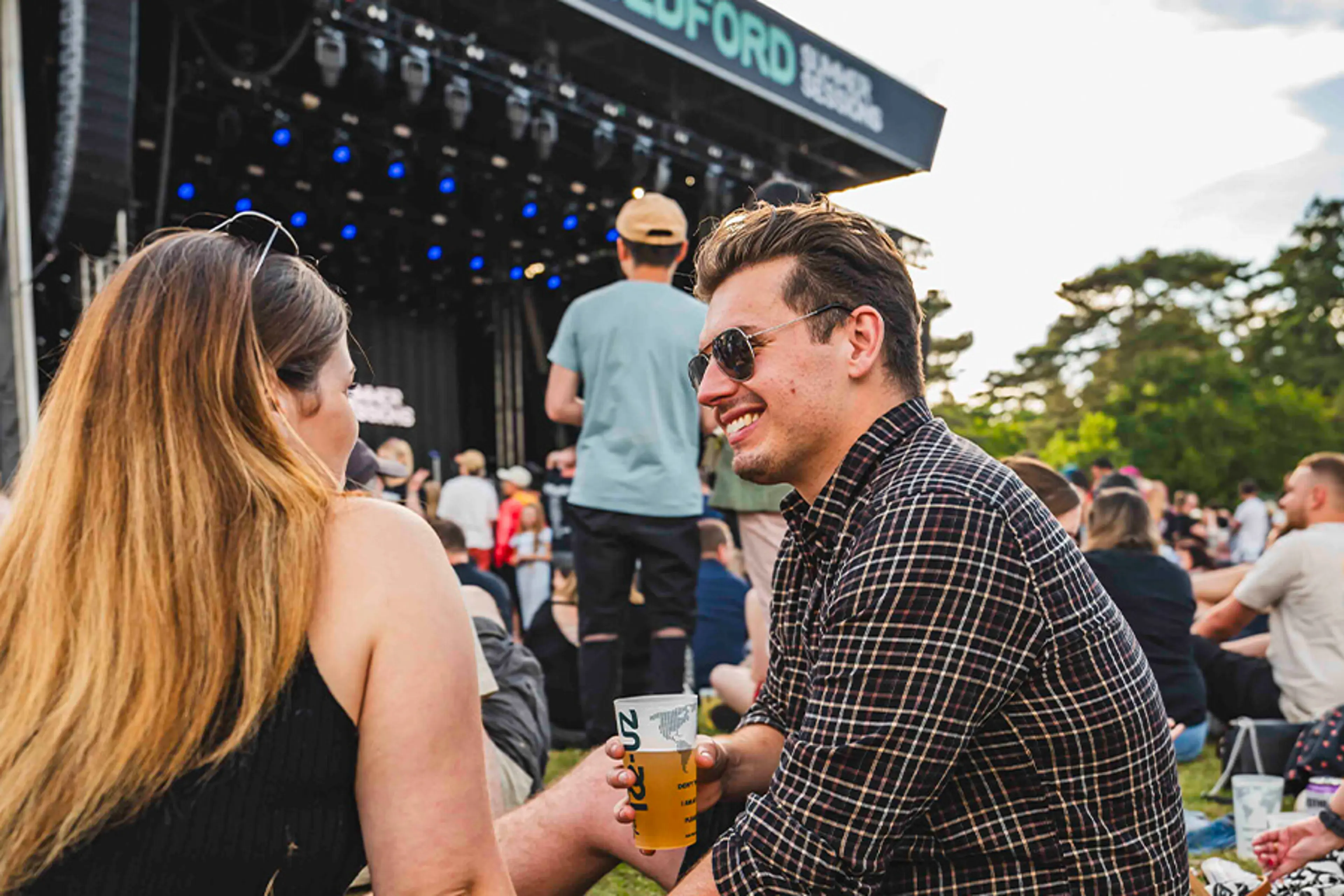 A couple enjoying a drink in front of the stage