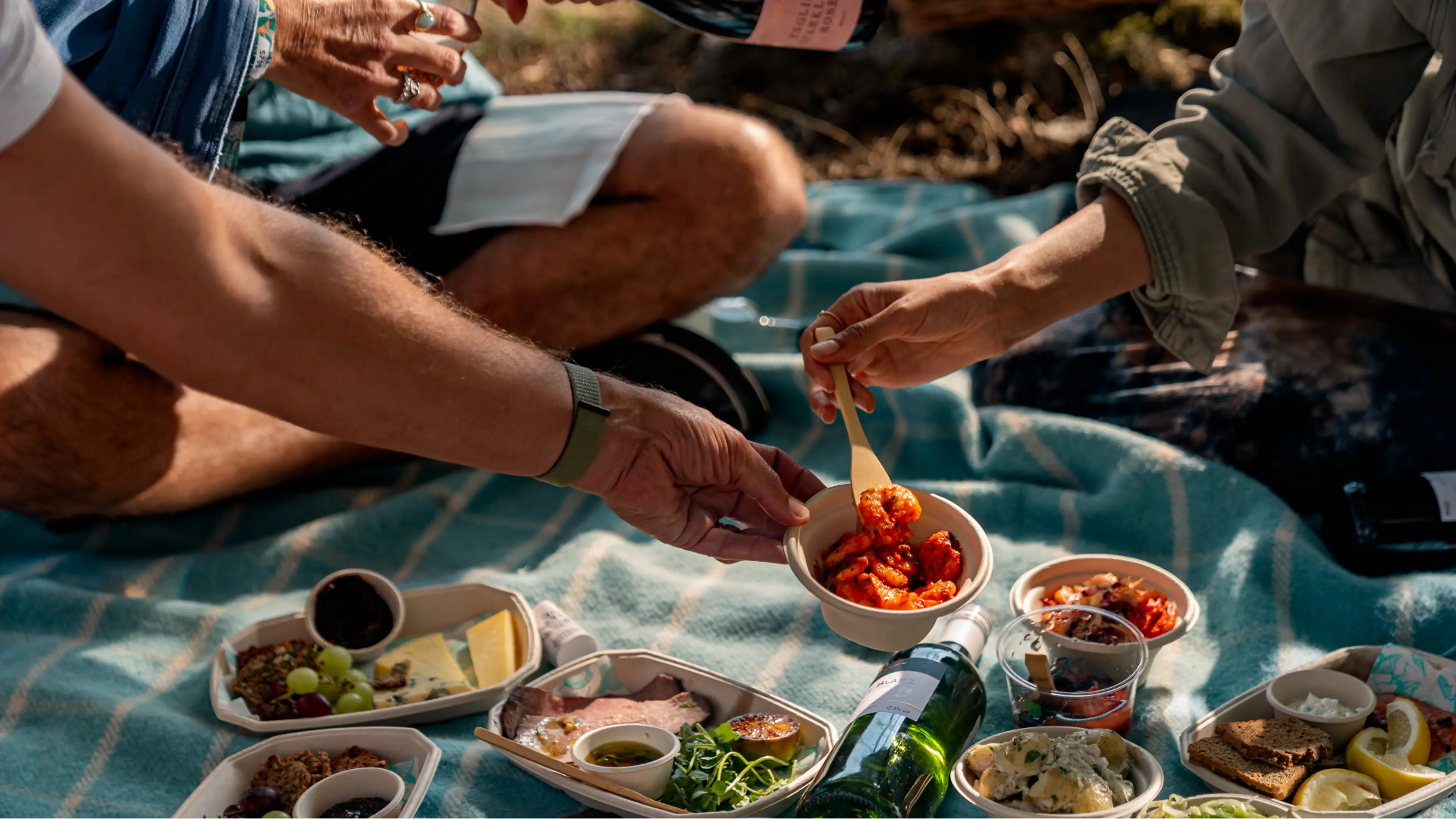 People enjoying the food in the Fortnum & Mason hamper