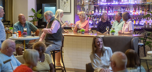 People enjoying the Botanical bar on board