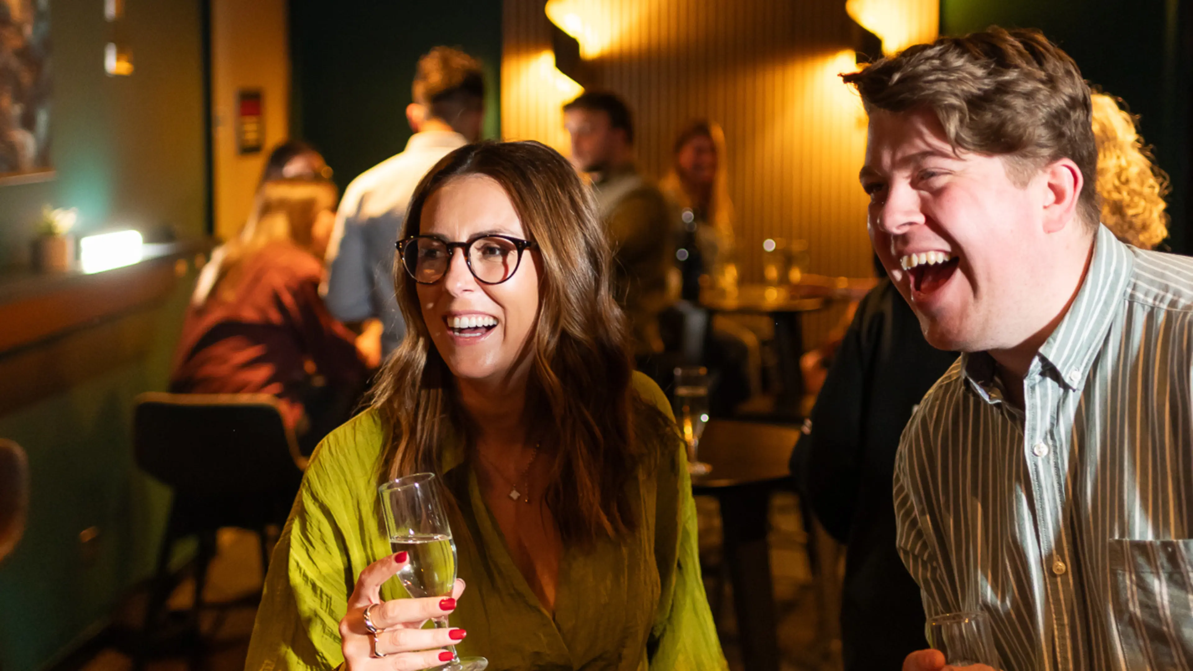 Two people laughing and chatting at The Suite Experience at Utilita Arena Cardiff.
