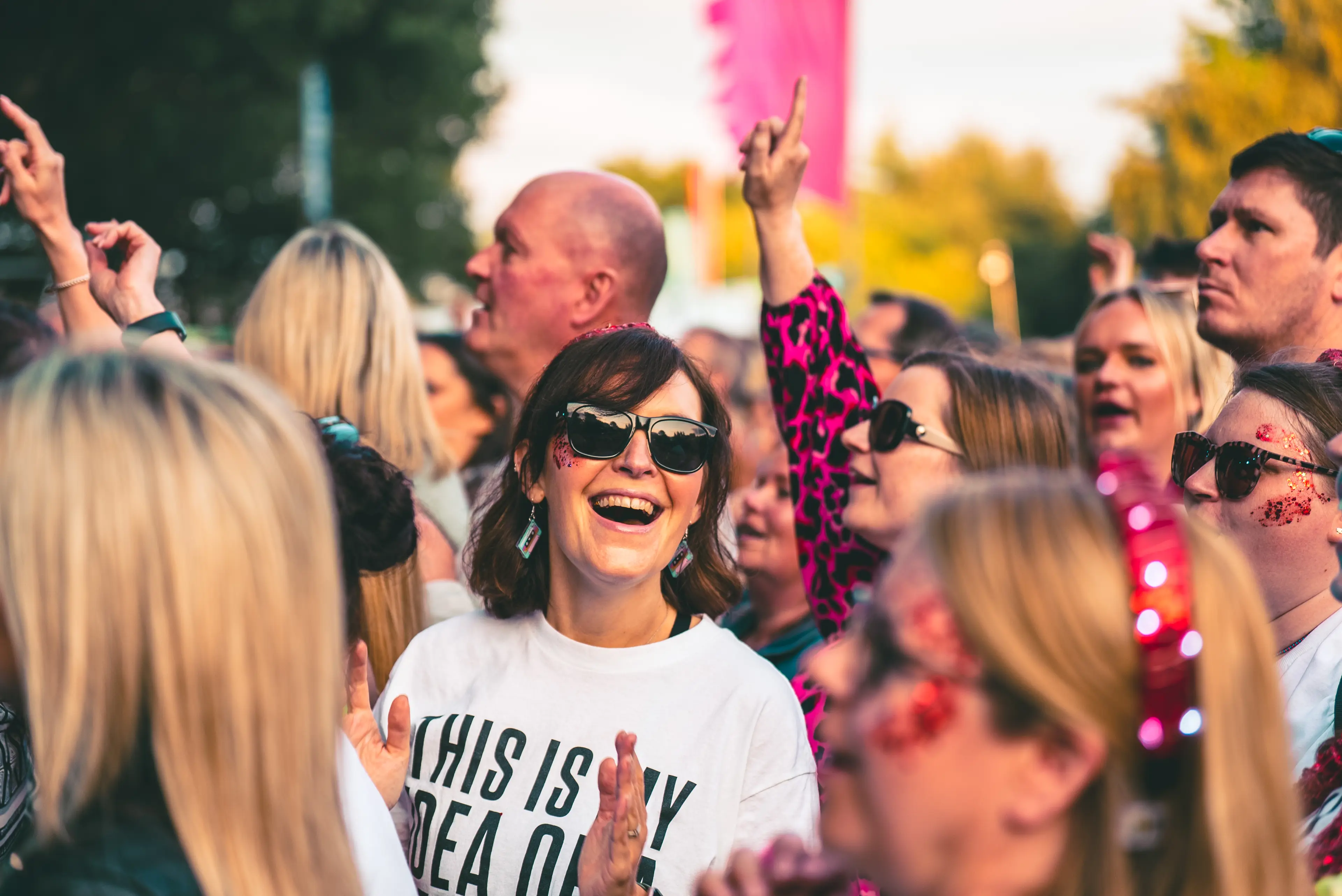 A women smiling in a crowd of people
