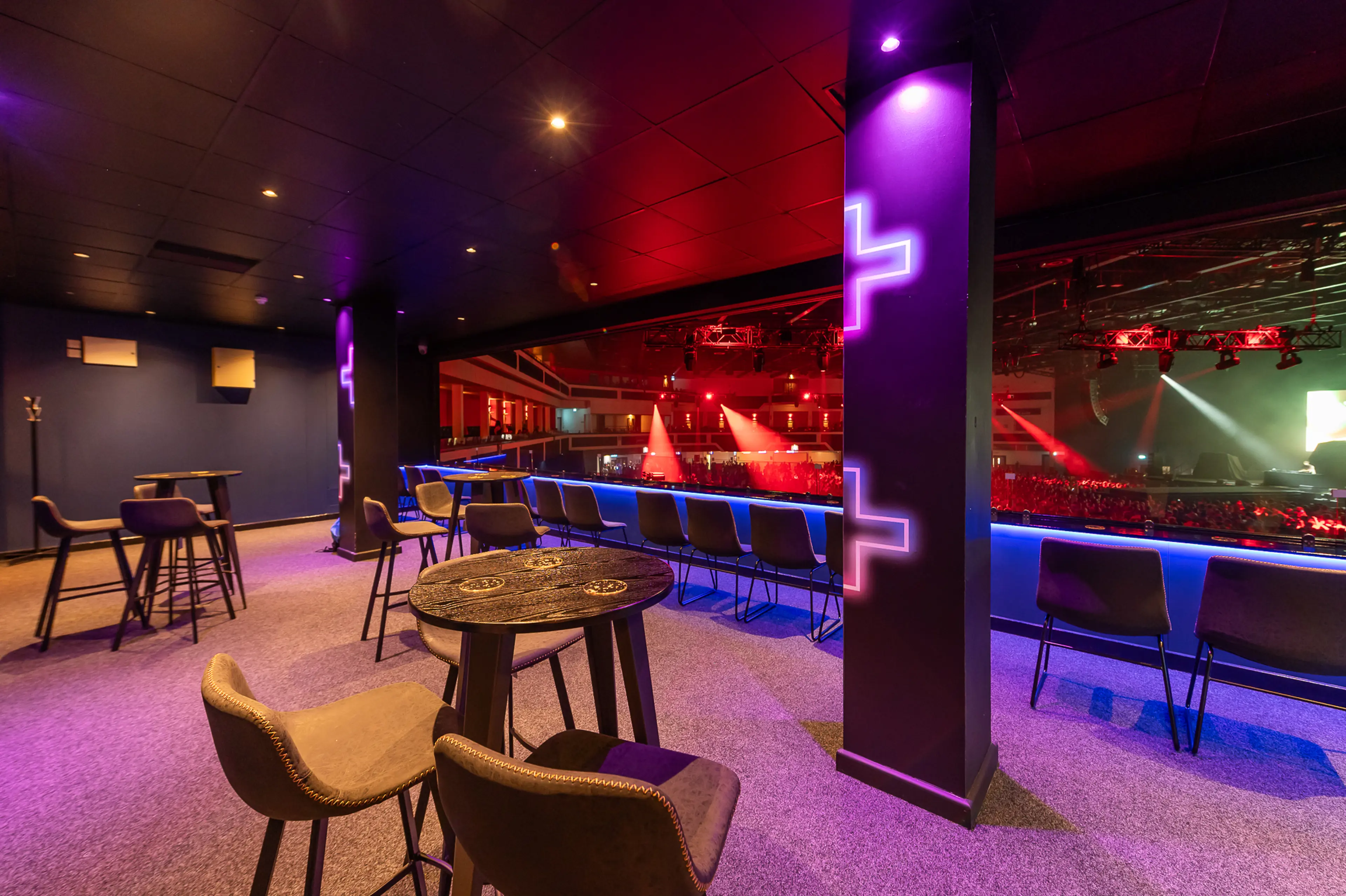 A view of the Energise Club at Utilita Arena Cardiff, with tables and chairs.