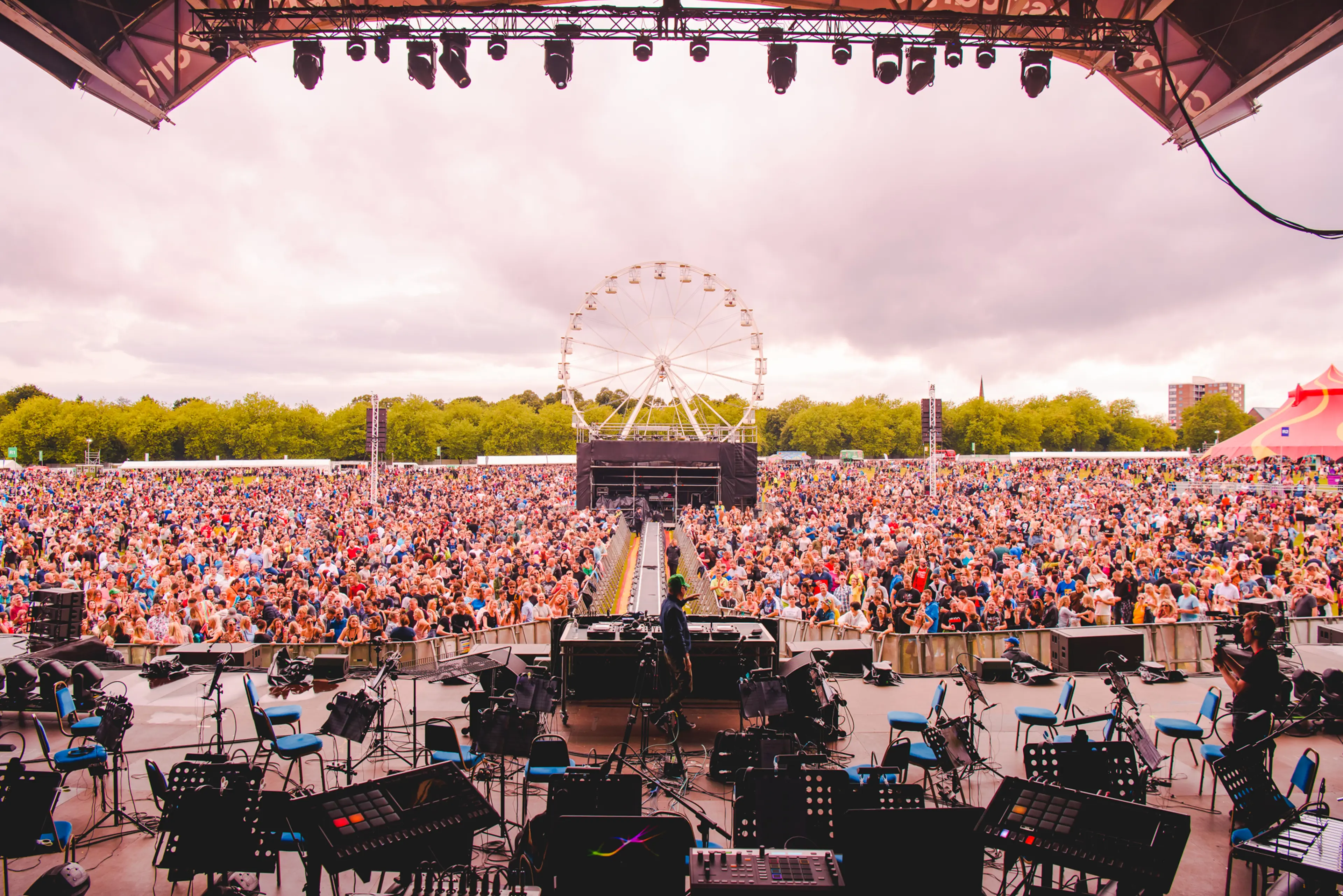 Stage with lights on and large crowd