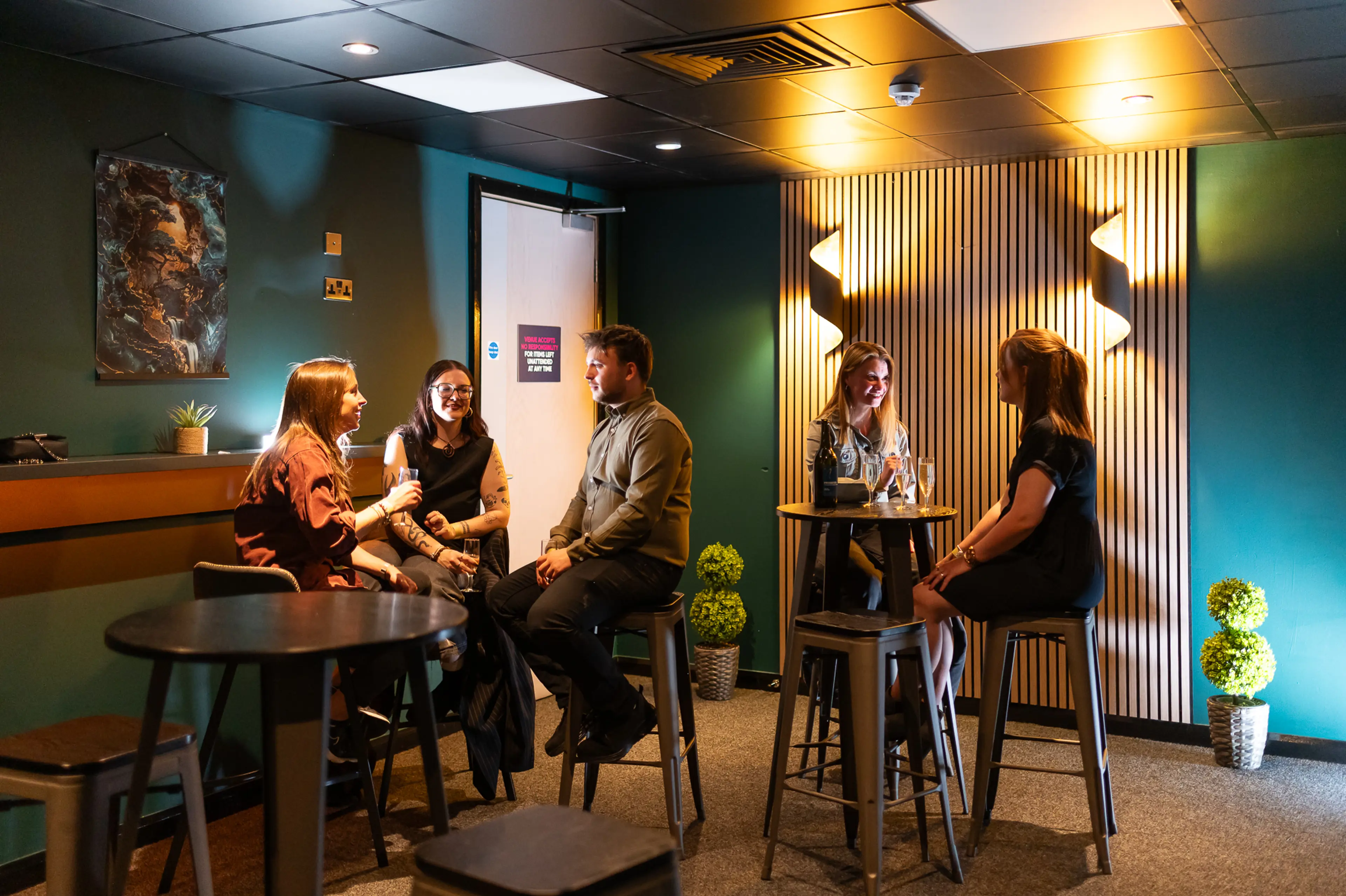 The Suite Experience at Utilita Arena Cardiff, full of people chatting, drinking and having a good time.